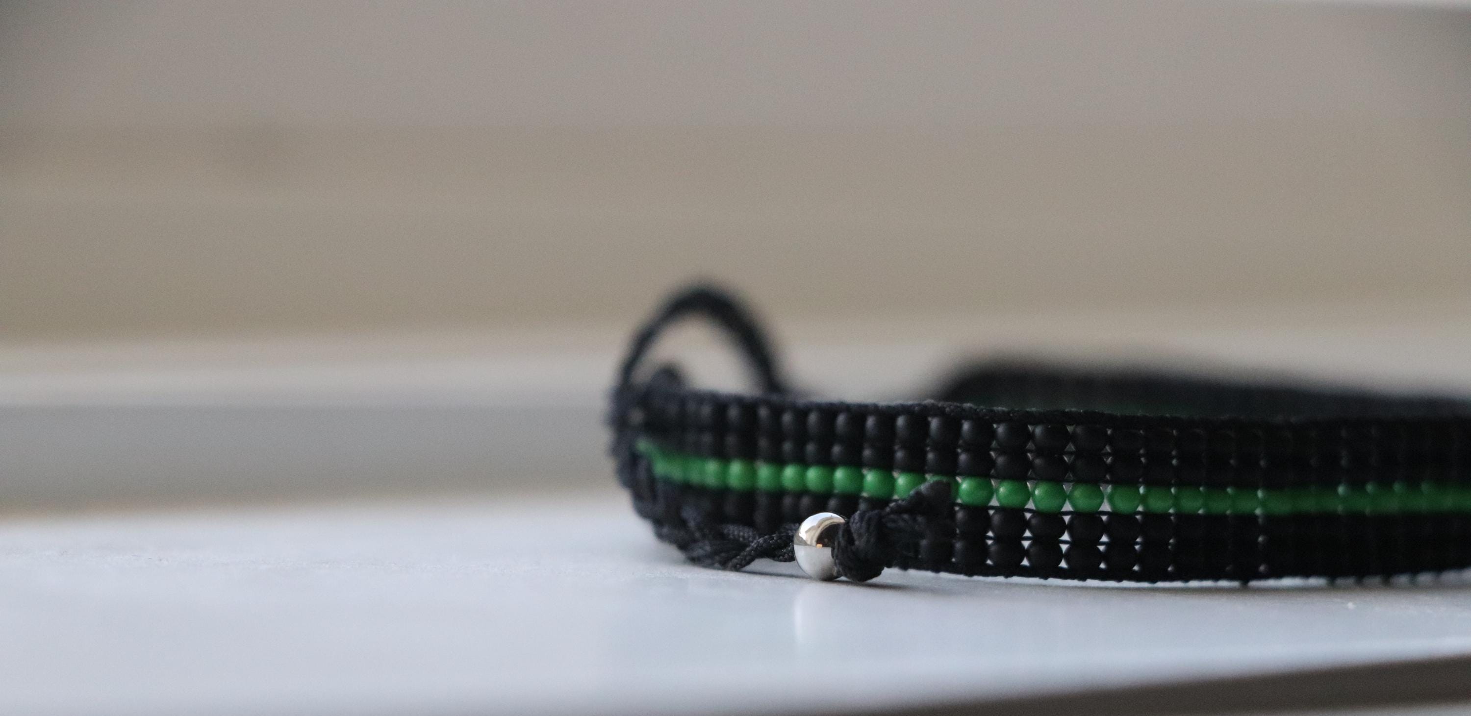 Black Bracelet with Green Line Design