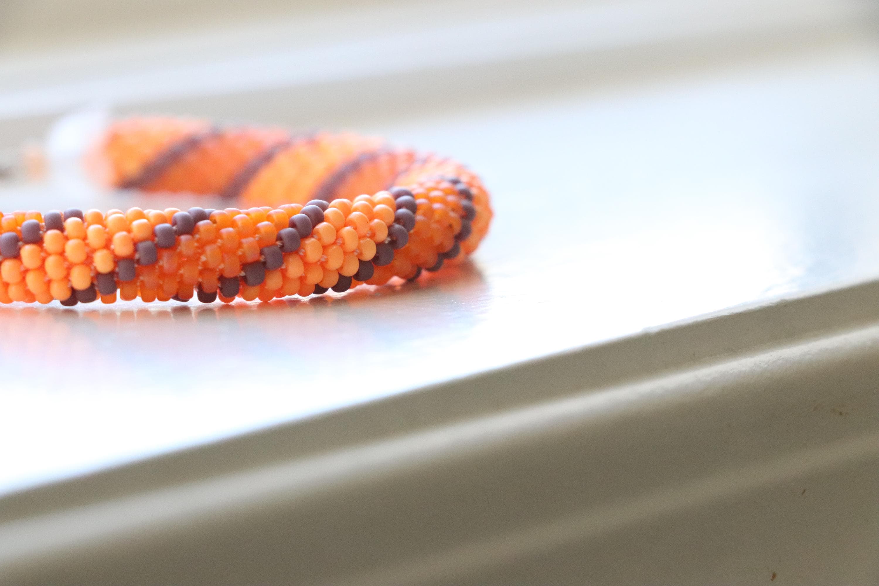 Handcrafted spiral orange bracelet